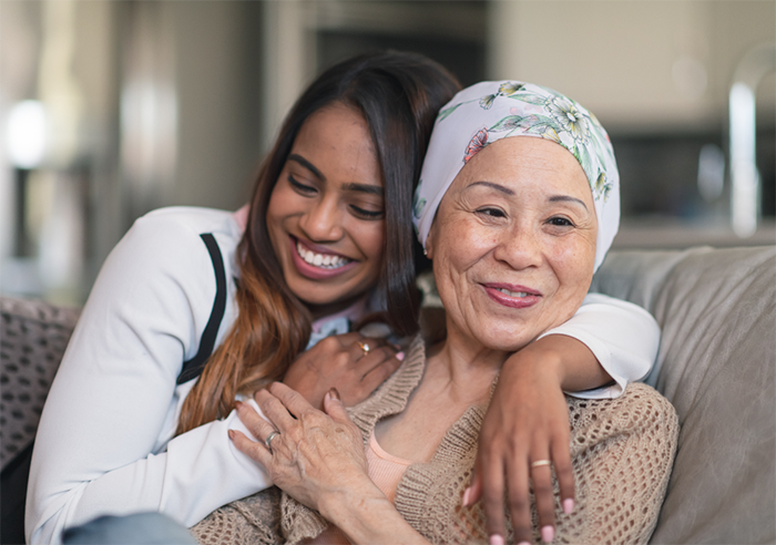 Mother and daughter sitting together smiling